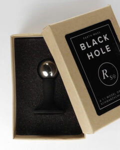 The black hole model box opened, revealing the black hole model on a stand